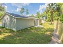 House exterior showcasing backyard access and a wooden privacy fence at 13099 Ne 7 Loop, Silver Springs, FL 34488