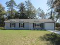 Inviting single-story home boasts meticulous landscaping and a convenient attached one-car garage at 13099 Ne 7 Loop, Silver Springs, FL 34488