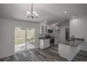 Open concept kitchen with island, stainless steel appliances, and gray countertops at 13099 Ne 7 Loop, Silver Springs, FL 34488