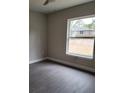 Bright bedroom with a window offering natural light and ceiling fan at 13380 Se 43Rd Ave, Belleview, FL 34420