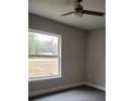 Spacious bedroom with large window and ceiling fan at 13380 Se 43Rd Ave, Belleview, FL 34420