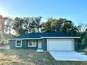 Newly constructed home with gray exterior and a two-car garage at 13380 Se 43Rd Ave, Belleview, FL 34420