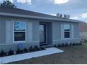 Front entrance of gray house with landscaping at 15155 Sw 52 Cir, Ocala, FL 34473