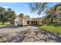 Side view of a ranch home with a long driveway at 15315 Nw 115Th Ct, Reddick, FL 32686