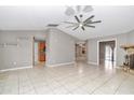 Open living room with tile floors, neutral walls, and a ceiling fan at 18300 Sw 69 Loop, Dunnellon, FL 34432