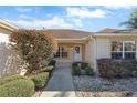 Welcoming front entry with a white door and walkway at 1982 Somerset Ave, The Villages, FL 32162