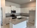 Beautiful kitchen featuring granite countertops, stainless steel appliances, and an island with a double sink at 2162 Nw 23Rd Loop, Ocala, FL 34475