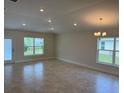 Spacious living room featuring neutral walls, ample natural light from two windows, and recessed lighting at 2162 Nw 23Rd Loop, Ocala, FL 34475