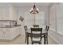 Kitchen features a dining area and white shaker cabinets at 4775 Nw 35Th Lane Rd, Ocala, FL 34482