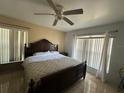 Primary bedroom with a king-size bed and large windows at 5242 Sw 162Nd Place Rd, Ocala, FL 34473