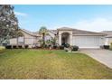 Single-story house featuring a well-manicured lawn and screened garage at 5470 Nw 26Th Lane, Ocala, FL 34482