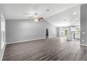 Spacious living room featuring a grey wall, hardwood floors and an open floor plan at 7084 Se 124 St, Belleview, FL 34420