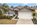 One-story house with a gray exterior and two car garage at 7402 Sw 99Th Ave, Ocala, FL 34481