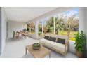 Relaxing screened porch with seating area and view of backyard at 7402 Sw 99Th Ave, Ocala, FL 34481