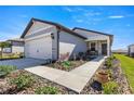 One-story house featuring a walkway, landscaping, and attached garage at 8332 Sw 54Th Loop, Ocala, FL 34481