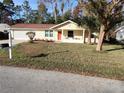 Ranch style home with red door and spacious lawn at 8623 Sw 108Th Place Rd, Ocala, FL 34481