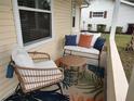 Relaxing front porch with wicker furniture and colorful cushions at 8623 Sw 108Th Place Rd, Ocala, FL 34481