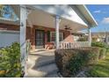 Covered porch with white columns and brick exterior at 8671 Sw 97Th St # C, Ocala, FL 34481