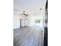 Bright and spacious living room with vinyl plank flooring and ceiling fan at 12314 Se 104Th Ter, Belleview, FL 34420