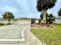 Inviting home showcasing palm trees, lush landscaping, and an attractive decorative driveway at 15715 Sw 11Th Terrace Rd, Ocala, FL 34473