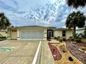 Charming home featuring a decorative driveway, tropical landscaping, and a welcoming entrance at 15715 Sw 11Th Terrace Rd, Ocala, FL 34473