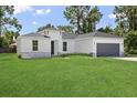One-story home with gray garage and stone accents at 15794 Sw 55Th Ave Rd, Ocala, FL 34473