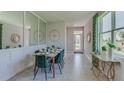 Elegant dining room with green velvet chairs and a modern table at 4062 Nw 44Th Cir, Ocala, FL 34482