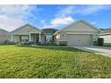 One-story home with stone accents, two-car garage, and manicured lawn at 5826 Sw 83Rd Ln, Ocala, FL 34476