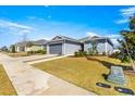 Cozy one-story home featuring a well-manicured lawn and a two car garage in neighborhood at 6411 Sw 78Th Avenue Rd, Ocala, FL 34474