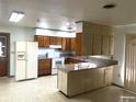 Eat-in kitchen features granite counters, modern white appliances, and breakfast bar at 691 Se 19Th St, Ocala, FL 34471