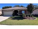 Landscaped one-story house with a two-car garage at 7729 Sw 85Th Cir, Ocala, FL 34481