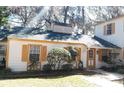 House exterior showcasing white walls, yellow accents, and landscaping at 7990 Midway Drive Ter # M102, Ocala, FL 34472