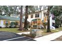 View of the building and surrounding area, showing parking and landscaping at 7990 Midway Drive Ter # M102, Ocala, FL 34472