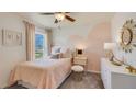 Light pink bedroom with a full bed, accent wall, and window at 8666 Sw 44Th Ter, Ocala, FL 34476