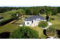 Expansive home with a lush lawn, mature trees and landscaping, and a black fence surrounding the perimeter at 9340 Sw 9Th Ter, Ocala, FL 34476