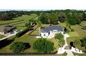 Expansive home with a lush lawn, mature trees and landscaping, and a black fence surrounding the perimeter at 9340 Sw 9Th Ter, Ocala, FL 34476