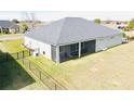 Single-story home with gray siding, gray roof, and a screened porch at 9645 Se 61St Ter, Belleview, FL 34420
