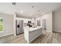 Modern kitchen with white cabinets, granite countertops, and stainless steel appliances at 10120 Se 130Th St, Belleview, FL 34420