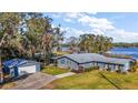 Lakefront property with house, detached garage, and spacious yard at 10455 Se 143Rd St, Summerfield, FL 34491