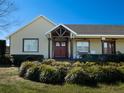 Front view of the house with red doors and landscaping at 11130 W Highway 326, Ocala, FL 34482