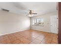 Bright living room featuring tile floors and a ceiling fan at 11250 Sw 79Th Ter, Ocala, FL 34476