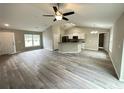 Open-concept living area with vinyl plank flooring and high ceilings at 15010 Sw 61St Court Rd, Ocala, FL 34473