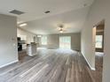 Spacious living room featuring an open floor plan and vinyl flooring at 15010 Sw 61St Court Rd, Ocala, FL 34473