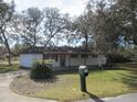 White house with covered patio, mailbox, and lush green lawn at 18782 Se 50Th St, Ocklawaha, FL 32179