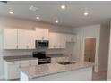Bright kitchen features granite counters, stainless appliances, and white cabinets at 2214 Nw 23Rd Loop, Ocala, FL 34475