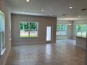 Open concept living area with tile floors, natural light, and neutral paint at 2214 Nw 23Rd Loop, Ocala, FL 34475