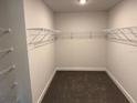 Walk-in closet featuring wire shelving and carpet flooring for ample storage space at 2214 Nw 23Rd Loop, Ocala, FL 34475