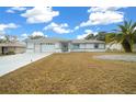 Single-story home with attached garage and neat lawn at 5894 Sw 102Nd Ln, Ocala, FL 34476