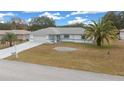 Single-story home with attached garage and palm tree at 5894 Sw 102Nd Ln, Ocala, FL 34476