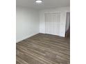 Spacious bedroom with new wood-look flooring and a large closet at 5921 Se 4Th Pl, Ocala, FL 34472